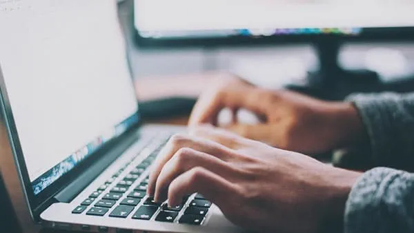 Man interacting with web page on laptop