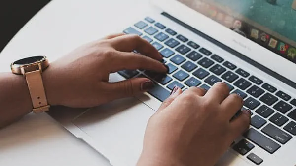 hands typing on laptop