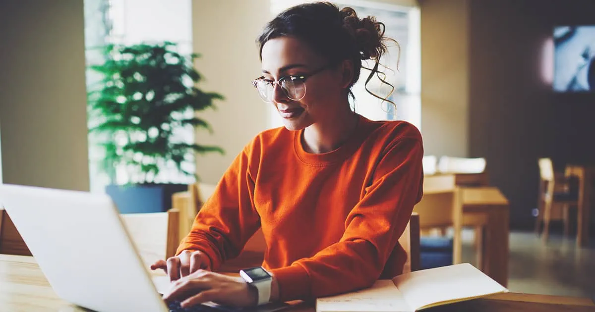 Professional content editor typing in a wireless laptop