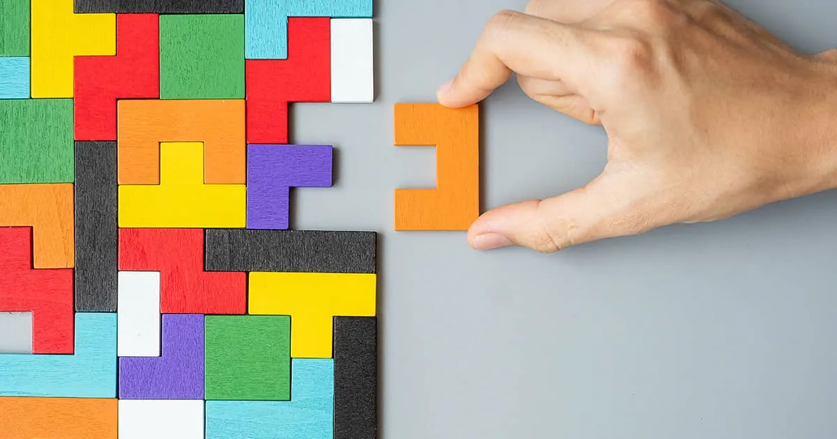 Hand connecting geometric shape block representing configurations