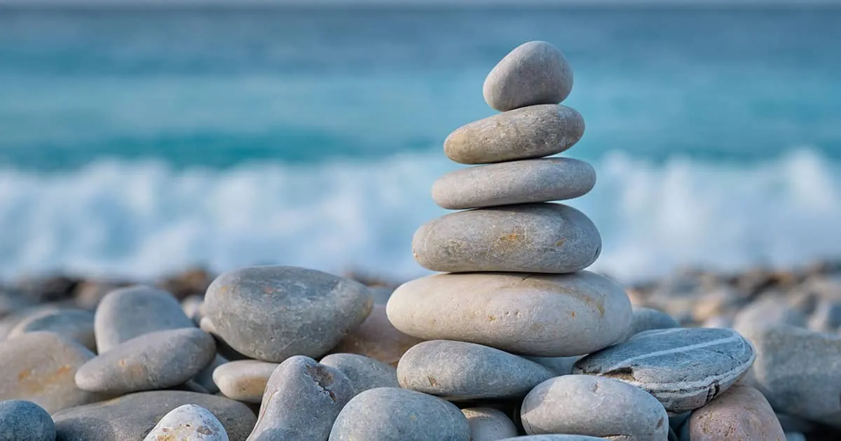 Balanced rocks on a beach representing stability